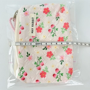 Detail view of floral strawberry coin purse showing 11cm width measurement with ruler