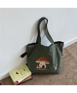 Detail of mushroom house embroidery on dark green canvas tote bag with drawstrings