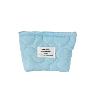 Light blue quilted floral makeup pouch with soft padding and silver zipper closure