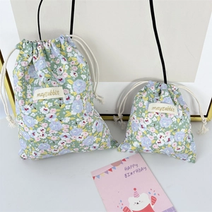 Detail of floral drawstring storage bags with cotton rope closure in two sizes