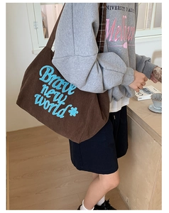 Brown corduroy tote bag with Brave New World embroidery and plaid lining details