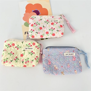 Three mini floral quilted canvas pouches with May Rabbit labels in cream yellow and blue