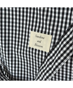Close-up of Gingham tote bag featuring a Sunshine and Blossom woven label and fine stitching