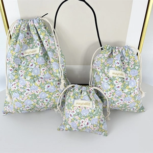 Detailed set of three floral drawstring storage bags in various sizes with purple flowers