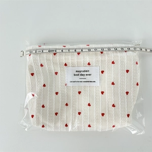 Top view of striped heart makeup bag with ruler showing 18.5cm width measurement