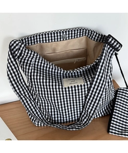 Detail of checkered canvas tote bag with metal snap button and small matching pouch