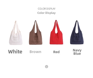 Detail view of tote bags in white, coffee, red, and navy with Never Say Goodbye embroidery