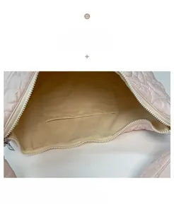 Detail view of pink quilted tote with heart pattern, soft beige lining and inner pocket
