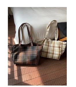 Detailed close-up of British plaid tote bag with corduroy edge stitching and dual straps