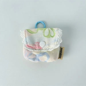 Detailed view of floral earbuds pouch with white lace trim and blue clip hook