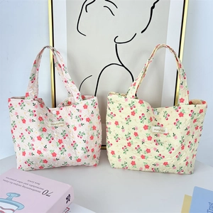 Floral quilted tote lunch bag with handle and button closure in pink and beige colors