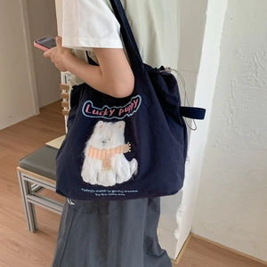 Navy blue canvas tote bag with cute cartoon puppy embroidery and drawstring closure