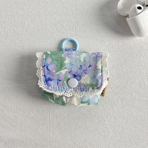 Detail of floral purple earphone case with white lace trim and plastic clip attachment