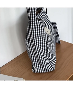 Detail of black and white gingham canvas tote bag with 'Sunshine and Blossom' fabric label