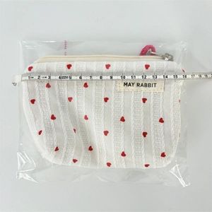 Detail showing the 16cm width of the white heart pattern makeup bag with zipper