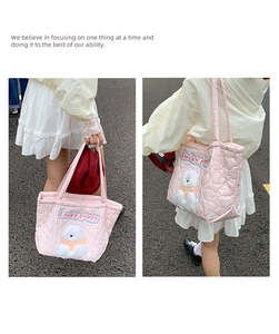 Detailed close-up of pink heart-quilted tote bag featuring cute polar bear embroidery