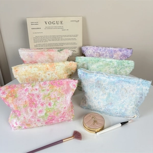Close-up of floral textured makeup bags in multiple colors with high-quality metal zippers