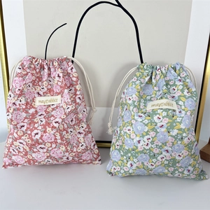 Floral drawstring storage bags in red and blue patterns for travel organization