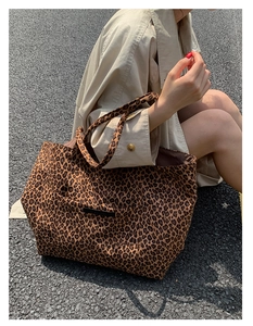 Detail of leopard print canvas tote bag with front pocket and durable shoulder straps
