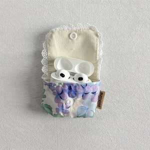 Detail of floral headphone case with white lace trim and secure button closure