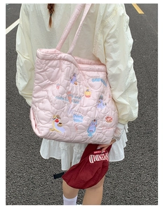 Pink heart quilted tote bag with colorful cat and dessert embroidery in a lifestyle view