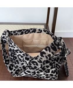 Detailed interior view of leopard print canvas tote bag with zipper pocket and magnetic snap