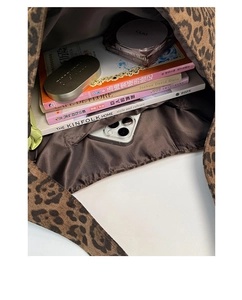 Macro view of leopard print tote bag interior with large capacity and functional pocket