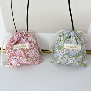 Floral drawstring storage bags in pink and green colors for travel organization