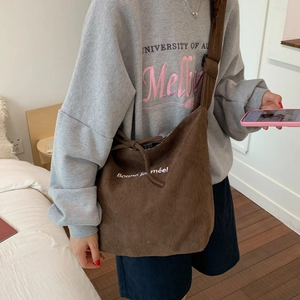 Brown corduroy crossbody bag with Bonne Journée text and adjustable wide shoulder strap