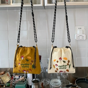 Nylon drawstring crossbody bucket bags with mushroom embroidery and woven shoulder strap