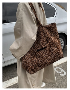 Detail of leopard print tote bag showing large capacity and external pocket on canvas