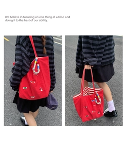 Detailed embroidery of mushroom and dachshund on red canvas tote with rainbow cord