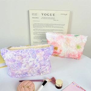 Floral plush makeup bag with fringe texture and metal zipper in soft lavender