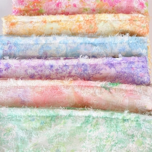 Close-up of colorful floral print fabric with unique fringe edges and soft textures