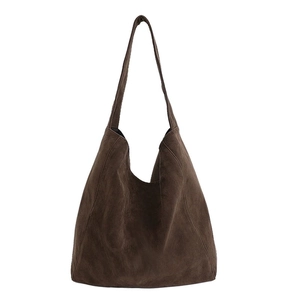Minimalist large brown suede tote bag with one-piece shoulder strap on white background