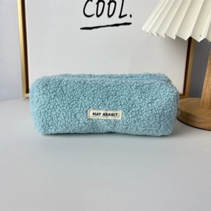 Close-up of fluffy light blue teddy fleece pencil case with MAY RABBIT woven label