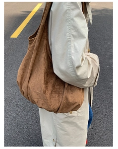 Brown suede tote bag shown on a model's shoulder for a minimalist daily fashion look