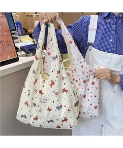 Detail of seersucker tote bags with cartoon puppy and heart patterns and cloth labels