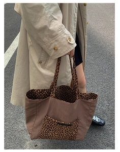 Detailed top view of large nylon leopard print tote bag showing spacious interior and pocket