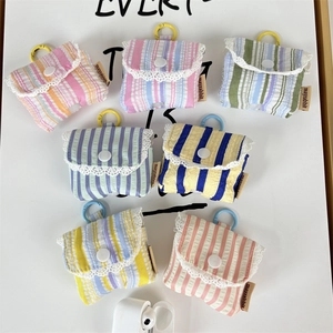 Detailed set of striped earphone pouches with white lace trim and colorful hooks