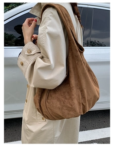 Brown oversized suede hobo tote bag shown on model for a retro urban casual look