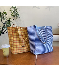 Close-up of vibrant checkered canvas tote bags in yellow and blue colors