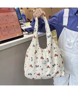 Close-up of white bubble texture fabric tote bag with cute cartoon animal prints