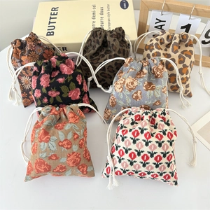 Detailed collection of mini corduroy drawstring pouches in floral and leopard prints