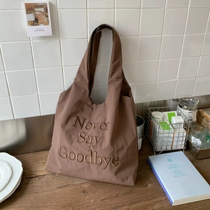 Brown nylon tote bag with letter embroidery and wide straps for casual commute style
