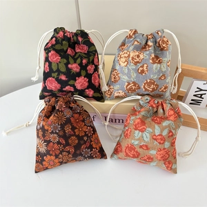 Set of four floral corduroy drawstring bags in black, blue, brown and beige colors