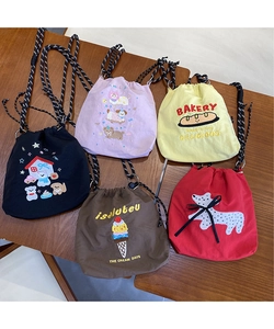 Detailed embroidery view on multi-colored canvas drawstring bags with metal buckles