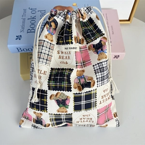 Detailed view of checkered bear canvas drawstring storage bag with cute patch patterns
