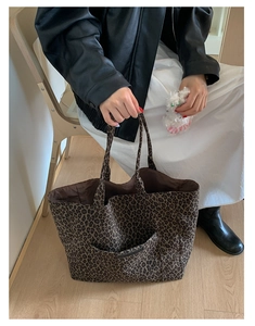 Detail of leopard print tote bag with outer pocket showing large capacity and thick texture