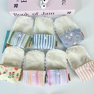Flat lay of multiple cotton earphone pouches featuring floral prints and lace edges